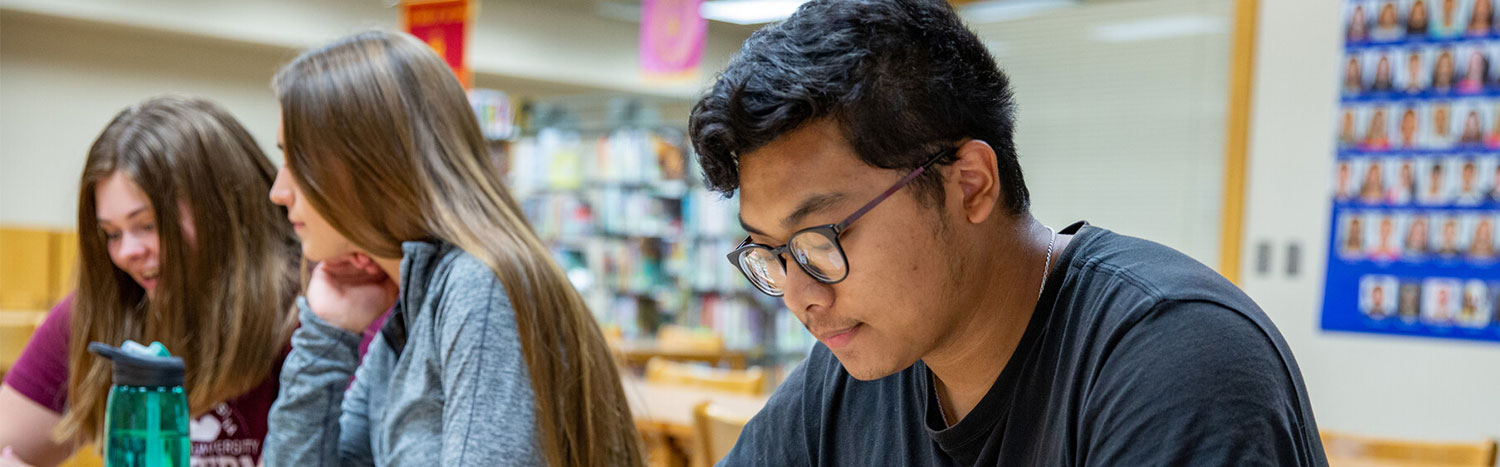 Three Students Studying in Library