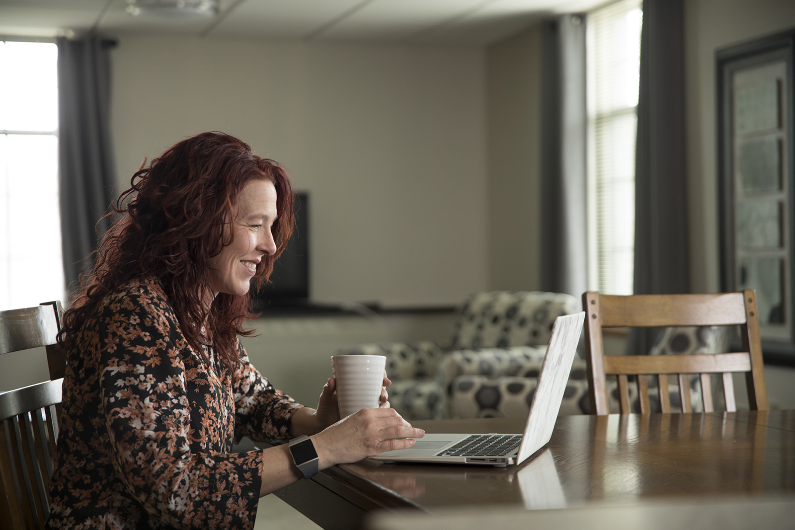 A woman works on her laptop at home