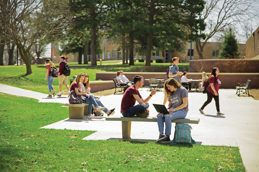 Students sitting outside on benches