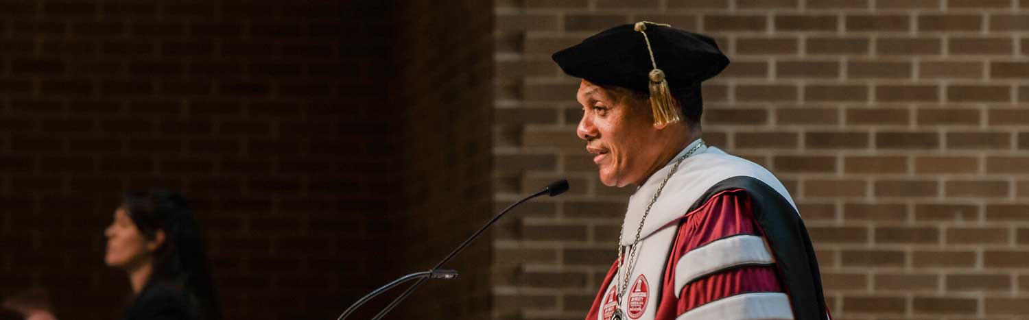 Dr. Mosley Standing At Podium At Inauguration