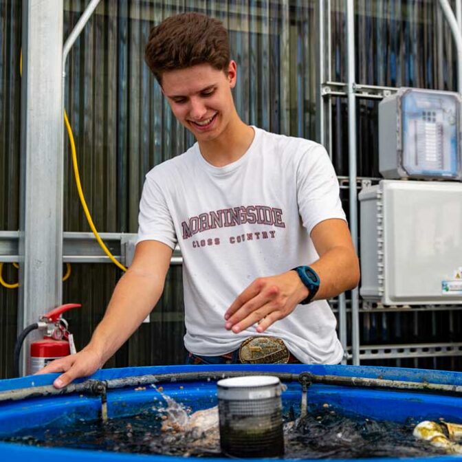 Ag Student Next To Fish Tank