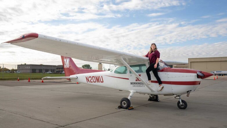 Female students state by a Morningside University plane.