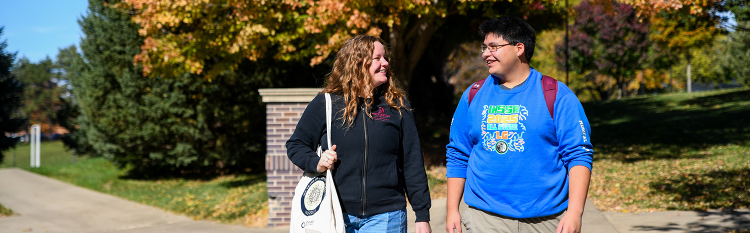 Two students walking through Morningside's campus