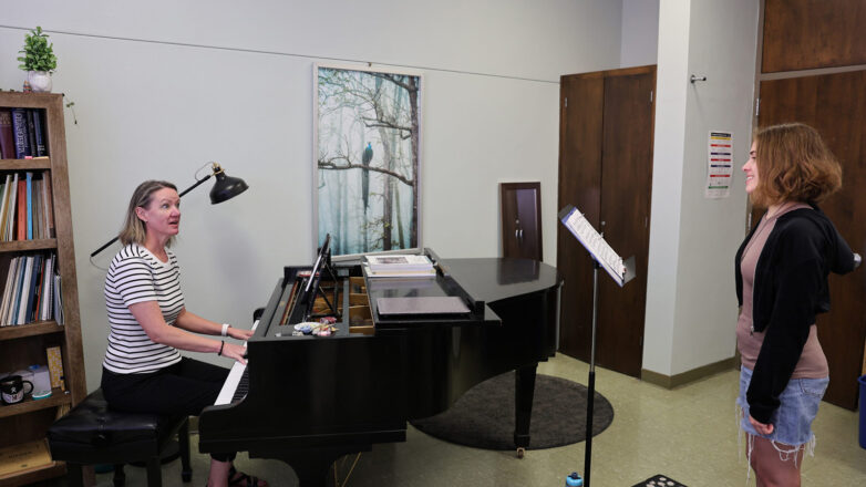 Faculty Member And Student With Piano