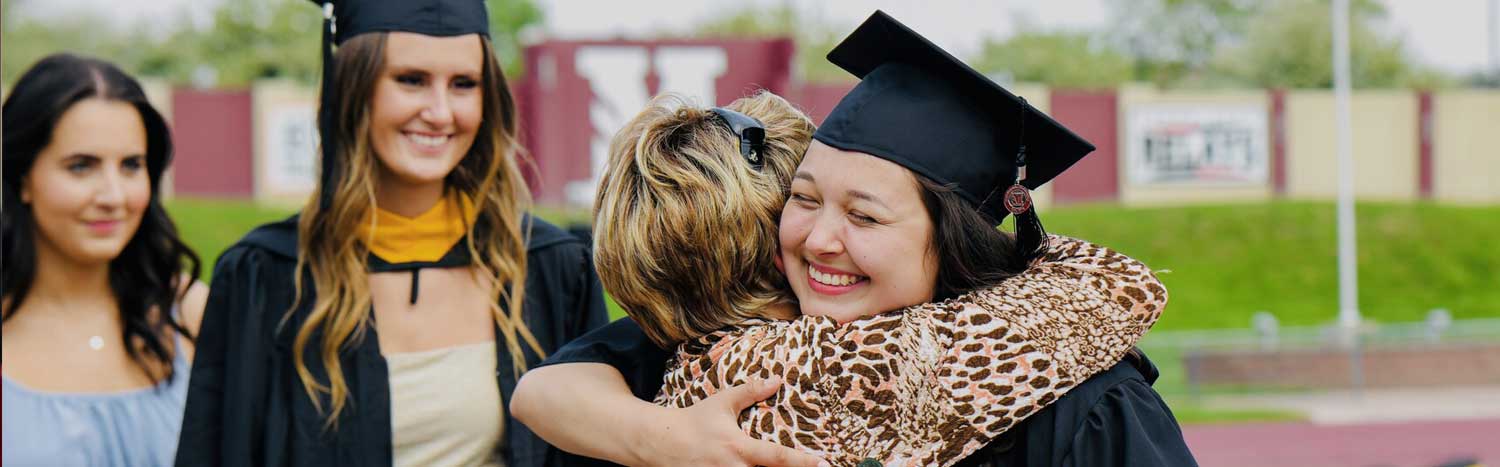 Graduate Hugging Someone