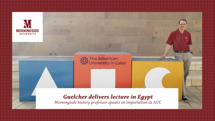 Dr. Greg Guelcher poses with a sign at American University of Cairo