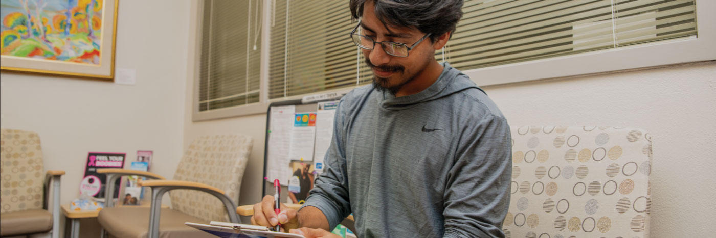 student filling out paperwork in health services