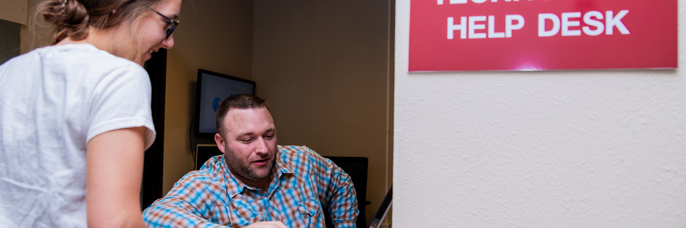 IT help desk staff helping student