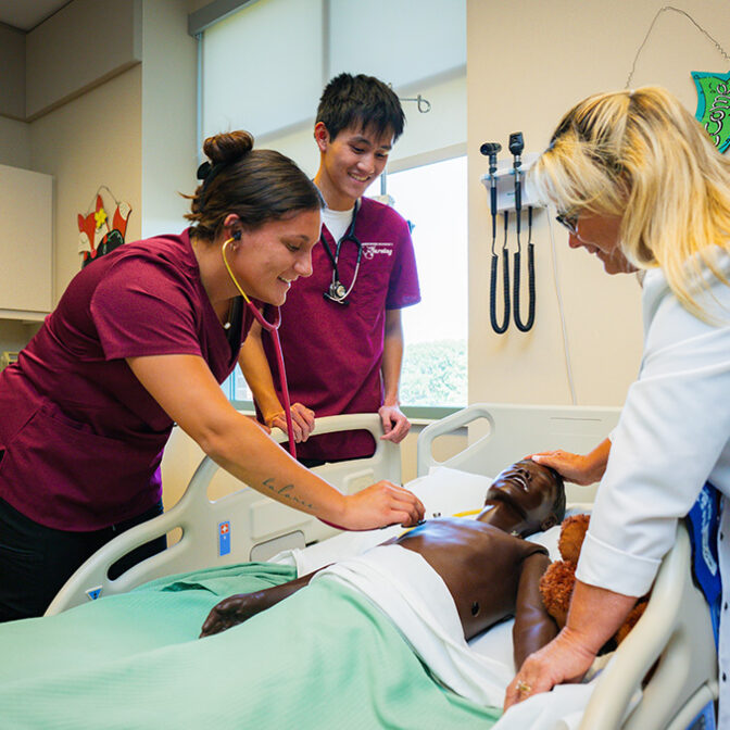 Nursing Students With Professor In Nursing Simulator