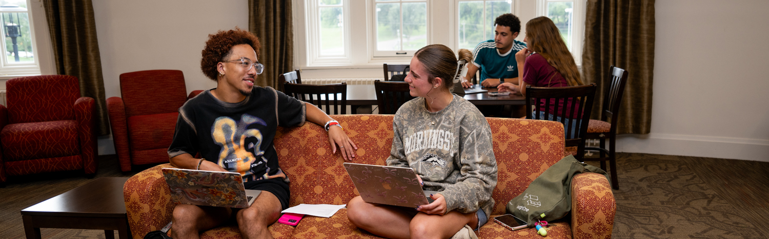 Students sitting in the lounge area of a university residence hall