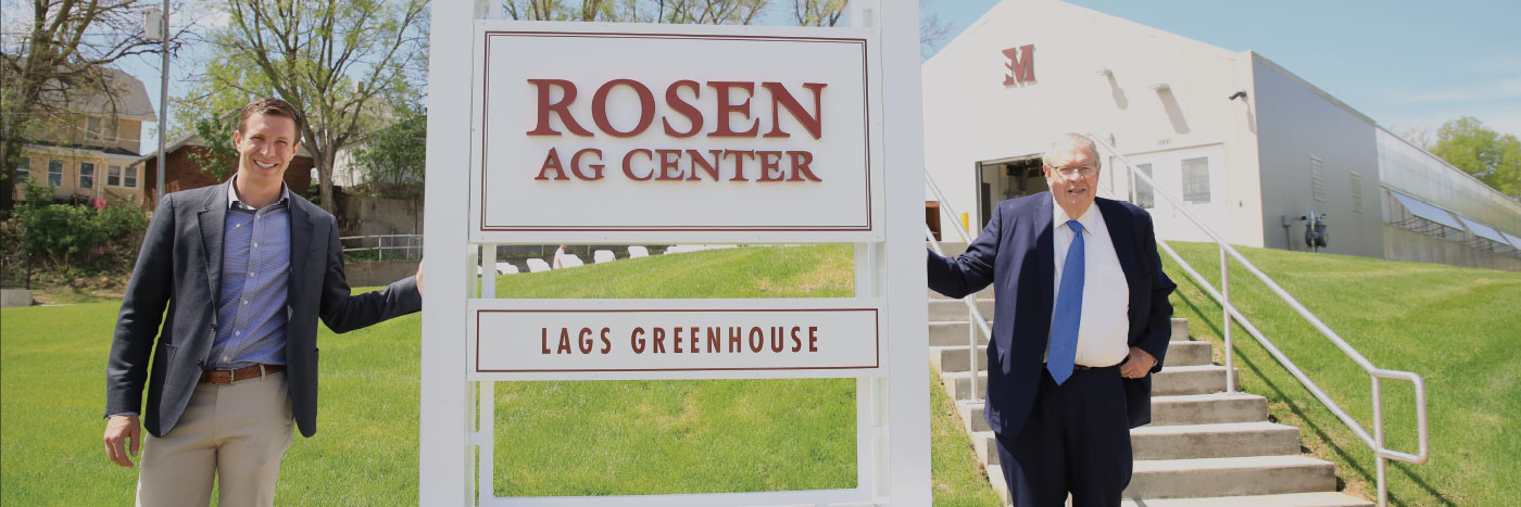 Rosen family in front of Rosen Ag Center sign