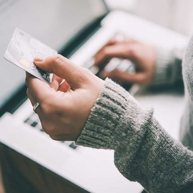 Someone Holding Credit Card With Laptop