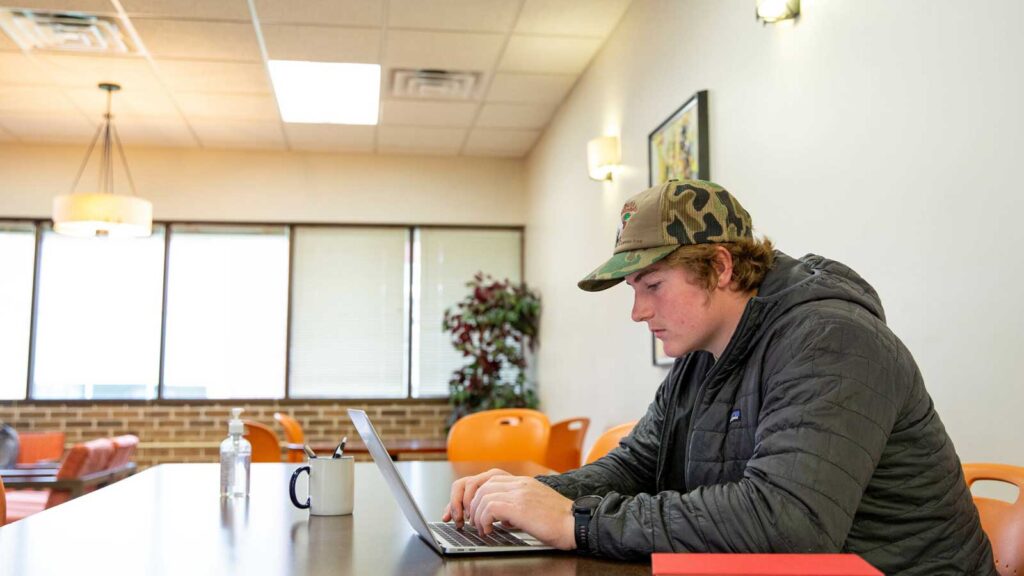 Student In Lincoln Center Studying On Laptop