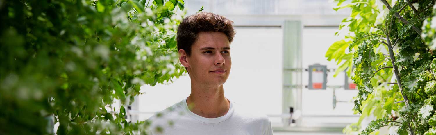 Student In Campus Greenhouse