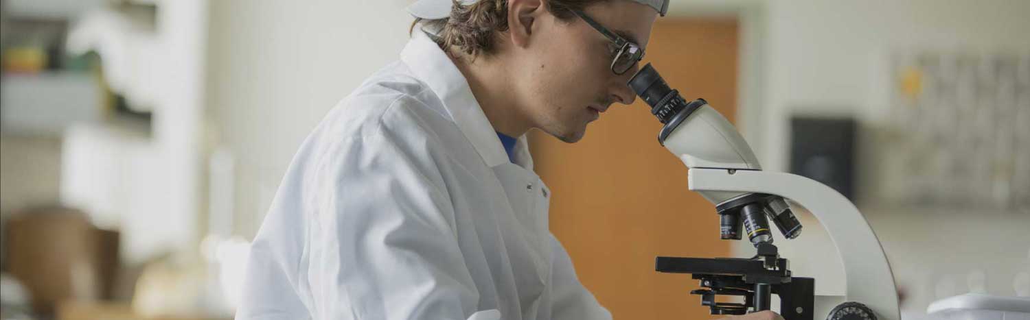 Student Looking Through Microscope