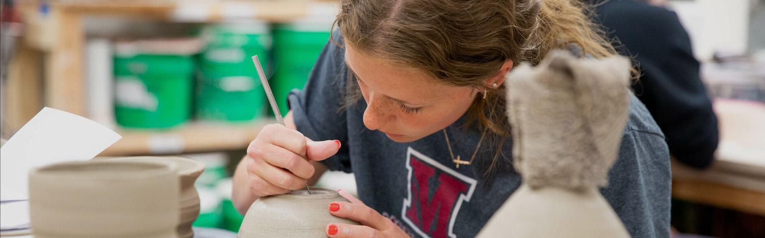 Student Working On Ceramic Pot