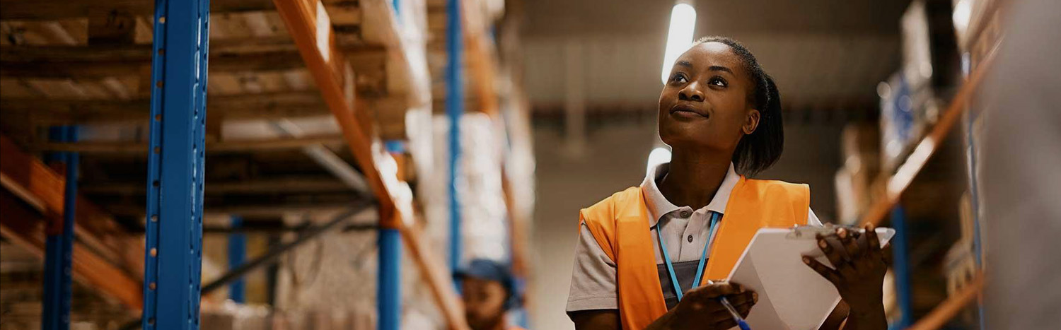 Supply Chain Manager In Warehouse With Clipboard