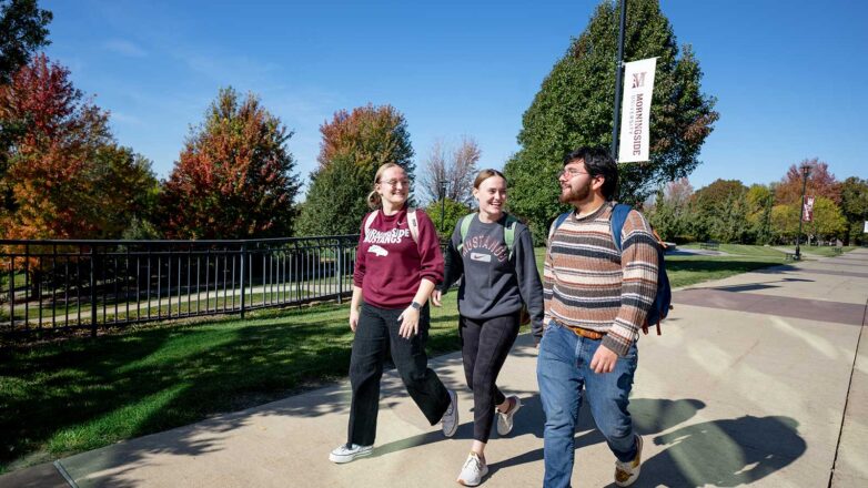 Three-students-walking-on-Morningside-University-campus