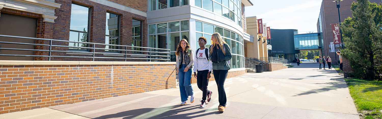 Three Students Walking On Morningside Campus Sidewalk