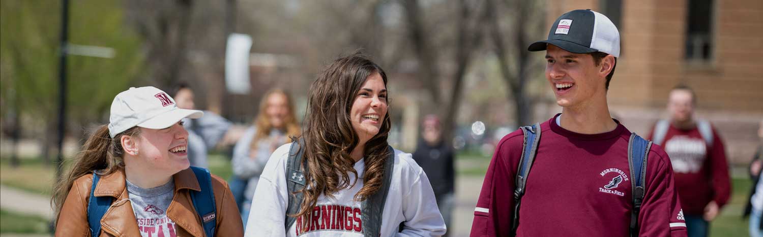 Three Students Walking On Campus