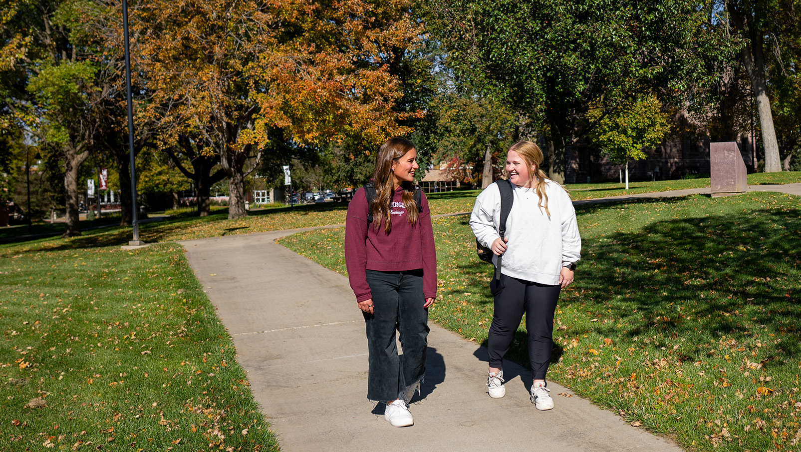 Two Female Students Walking On Morningside University Campus In The Fall