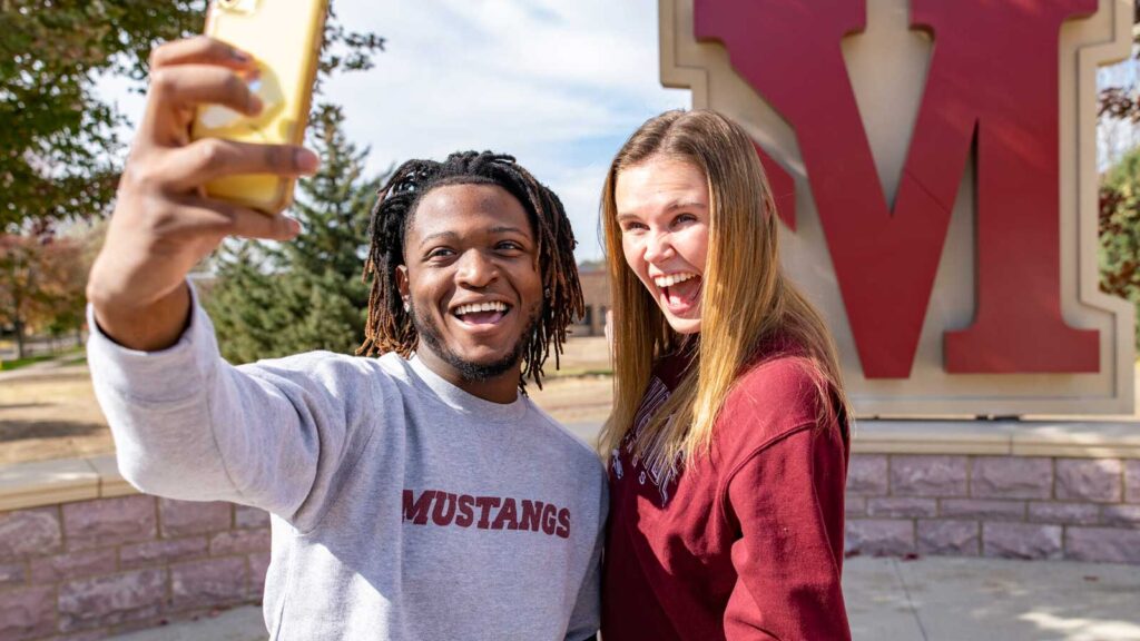 Two Students Taking Selfie In On Plaza