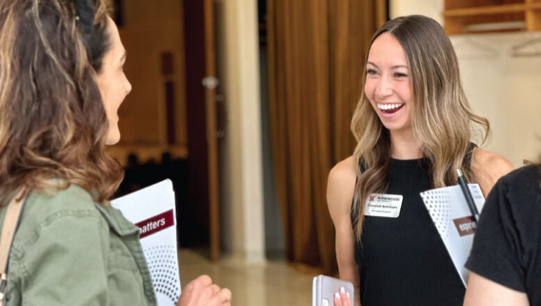 admissions counselor laughing with family