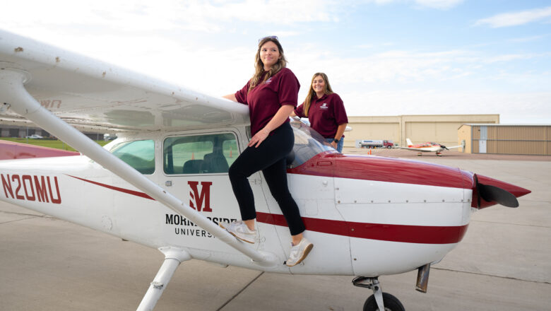 Two students posing on a Morningside airplane