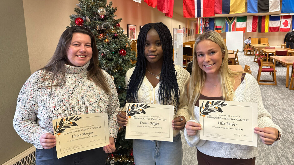 Essay contest winners pose for photo with their awards.