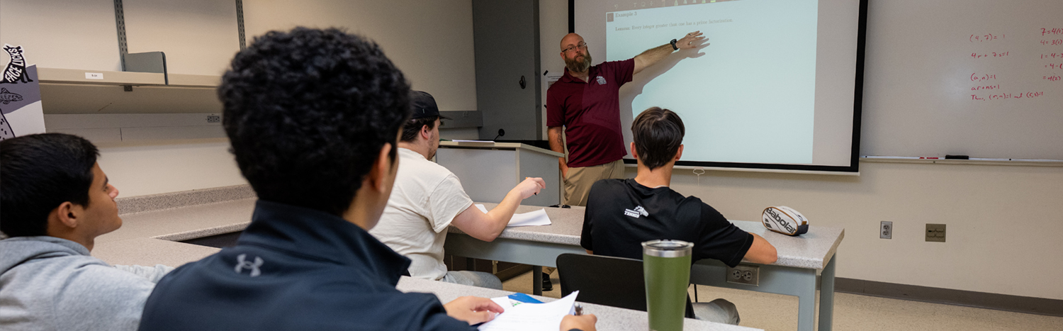 Students sitting in a classroom listening to a lecture