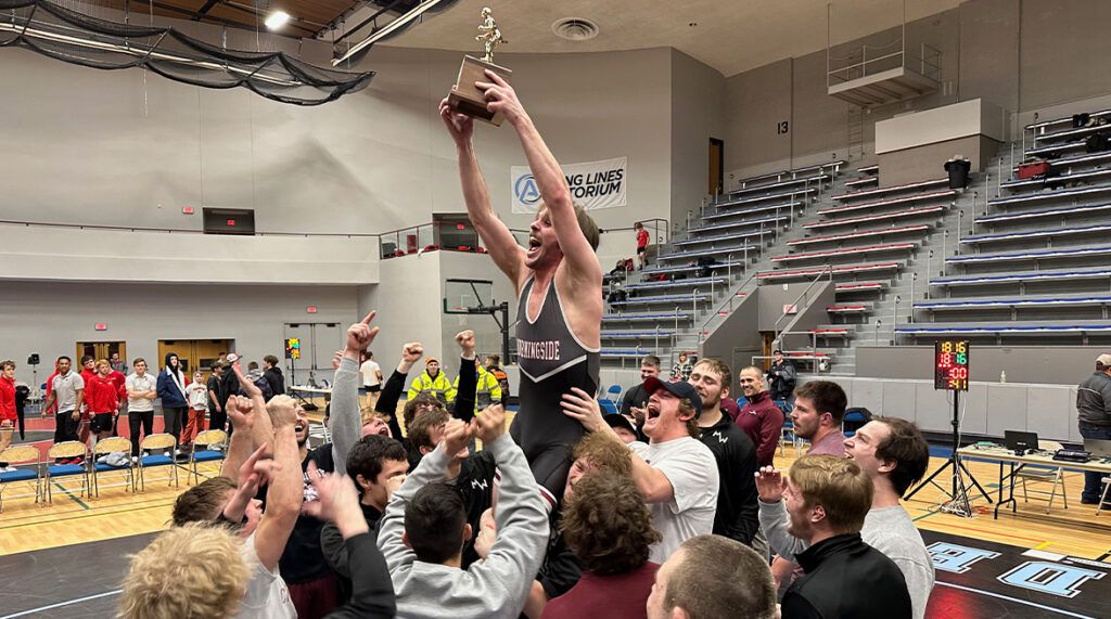 The men's wrestling team celebrates winning a conference championship