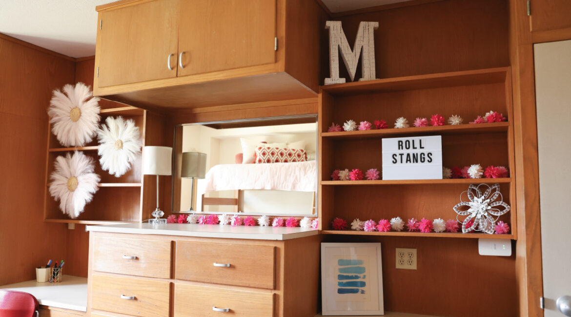 Close up of the build in desks, shelving, and dressers in a room in Roadman hall.