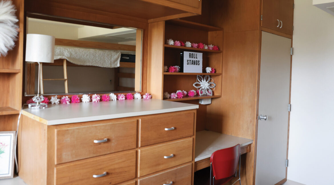 Close up of the build in desks, shelving, and dressers in a room in Roadman hall.