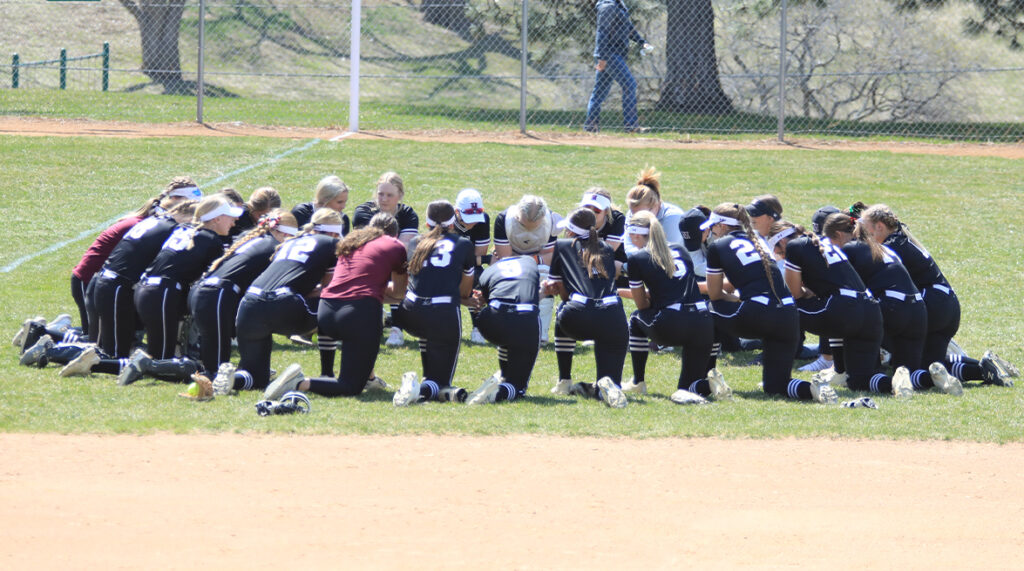 Morningside softball gathers in a huddle