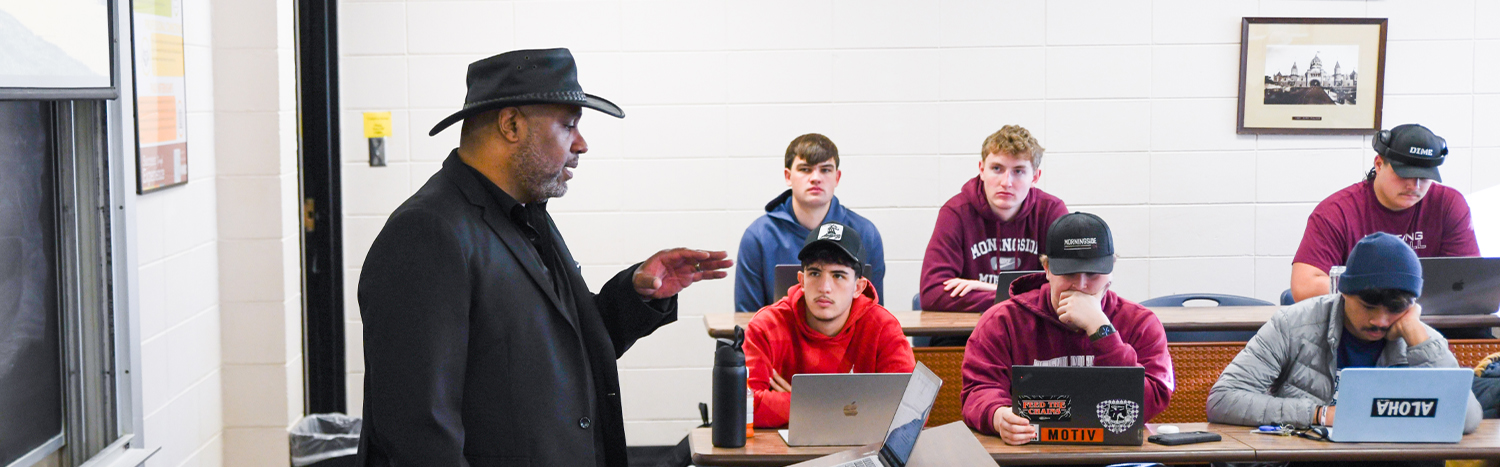 Professor lecturing to students in a classroom