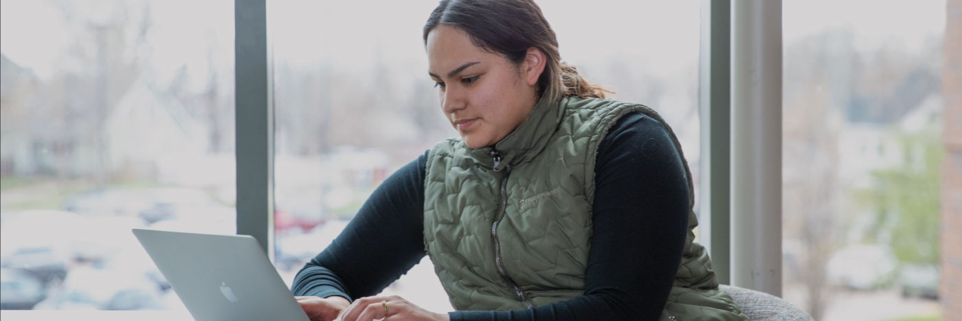 student studying at computer alone