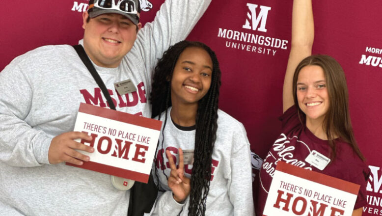 students with welcome home signs