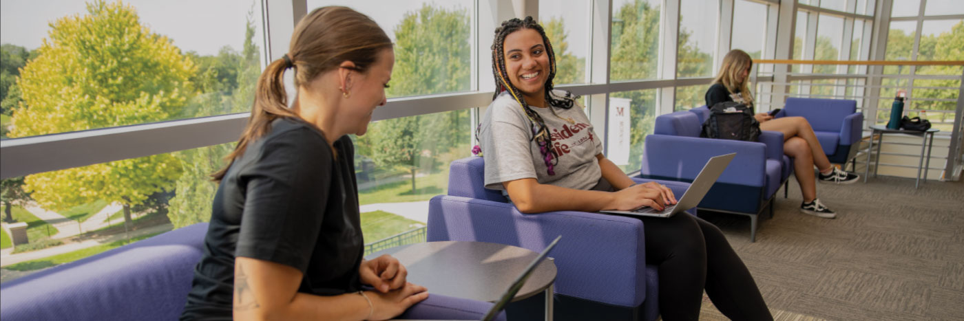 students laughing in library together