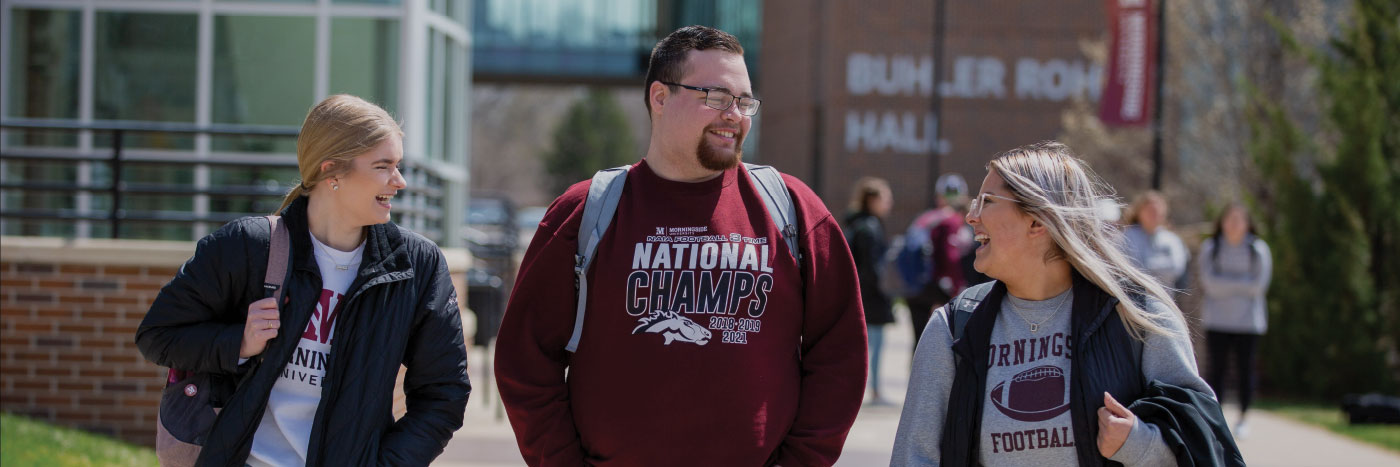 three students walking on the mall