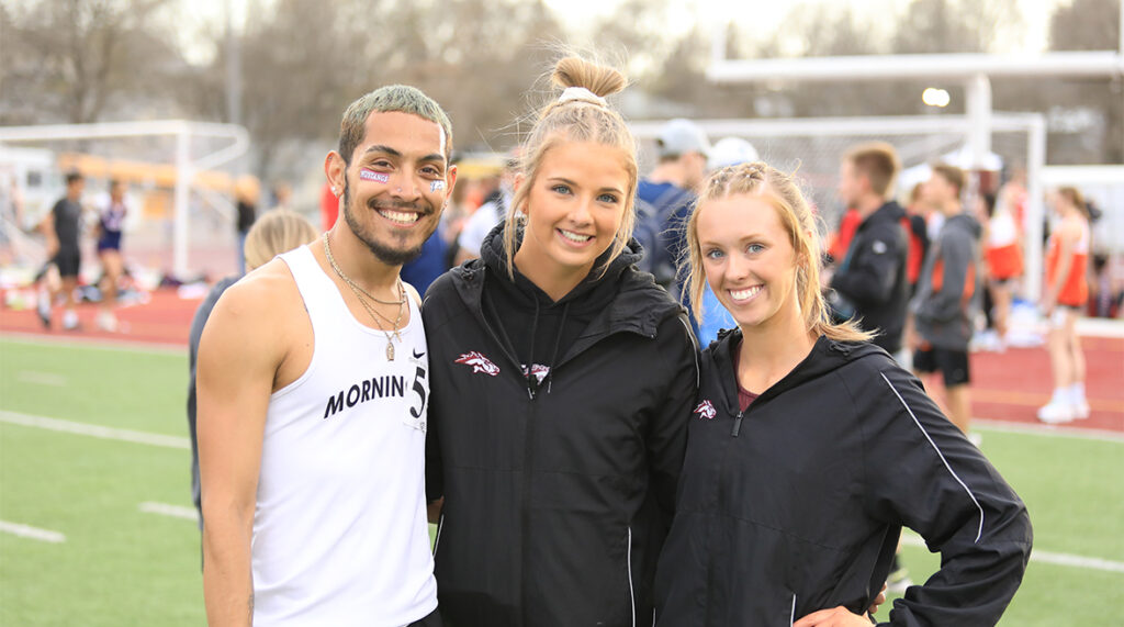 Three Morningside track and field athletes pose for a photo