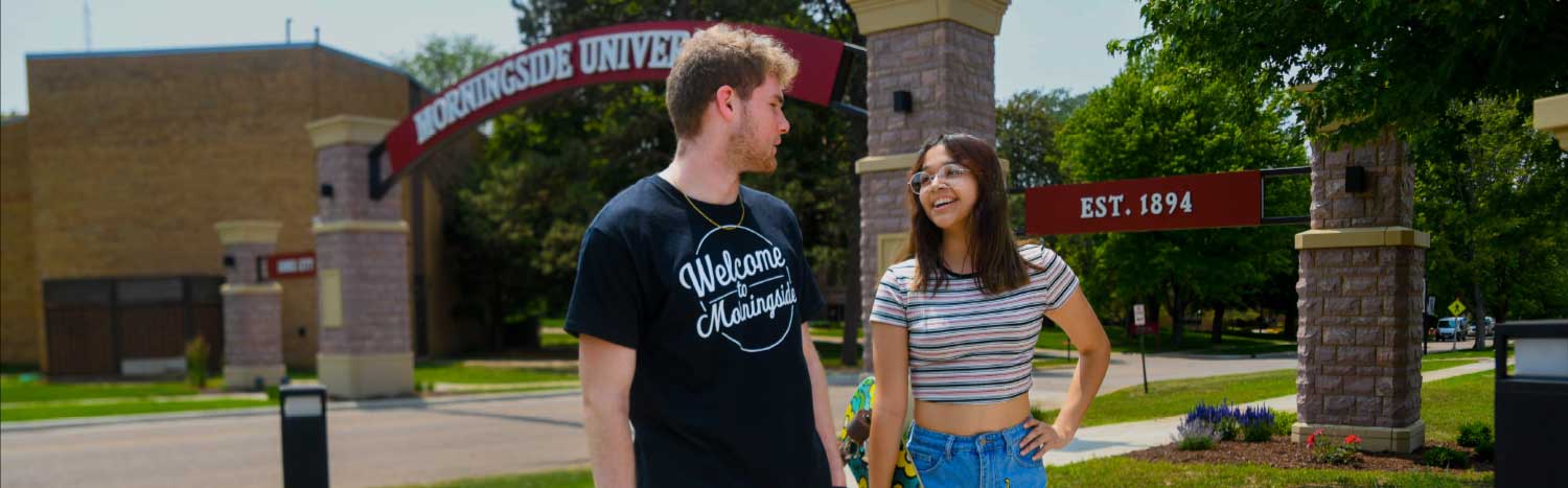 two students walking under Morningside arch