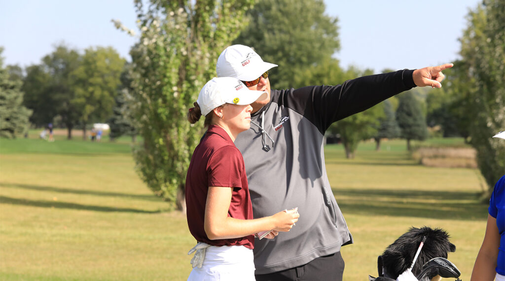 Morningside's golf coach gives a player pointers before a tee shot.